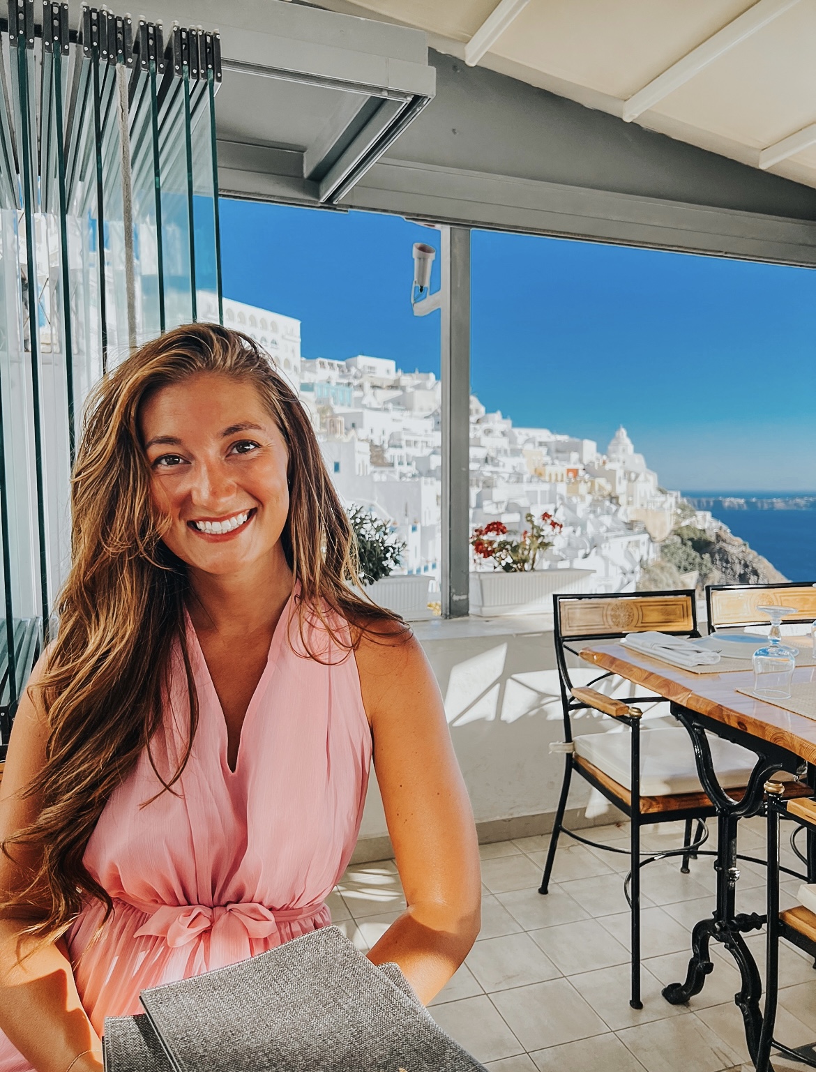 Courtney Psinas in Greece eating dinner on a terrace